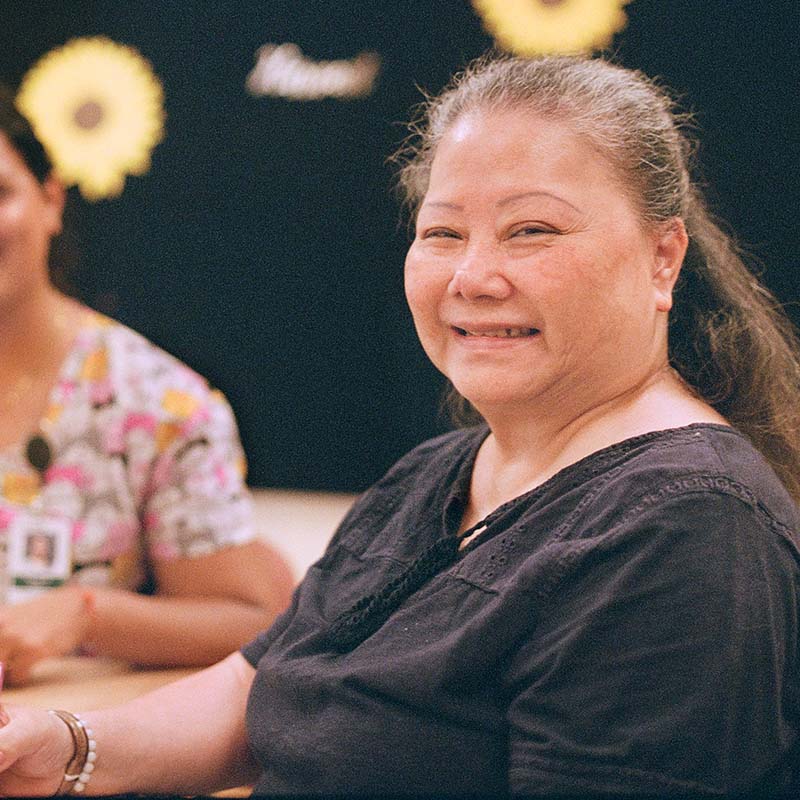 A smiling woman in a black blouse