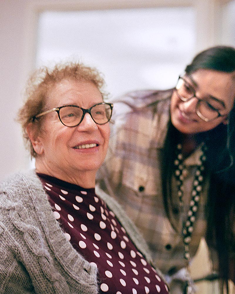 A smiling senior with glasses