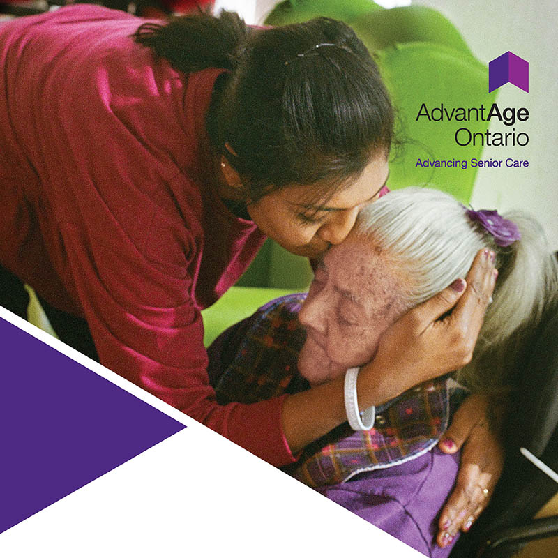 Woman kissing senior woman on the forehead