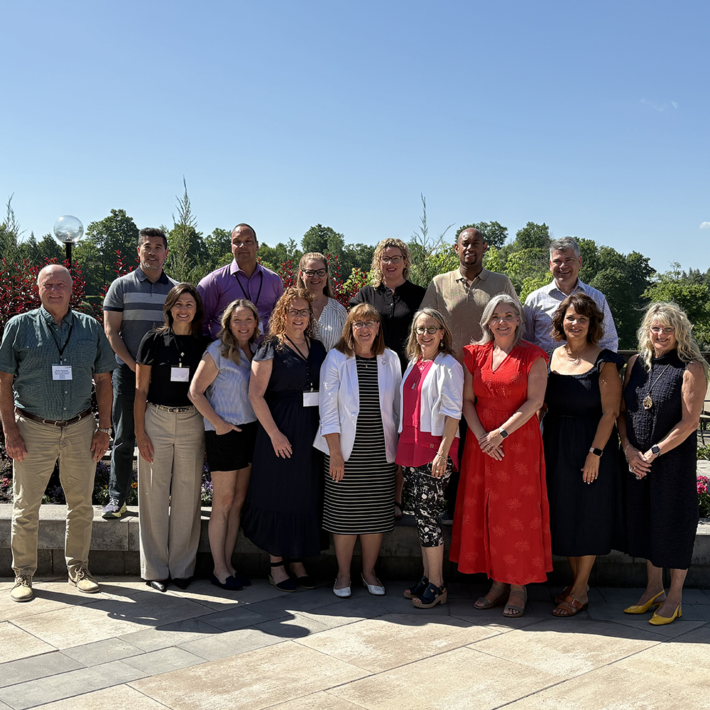 AdvantAge Ontario Board members post for a photo outside on a sunny patio